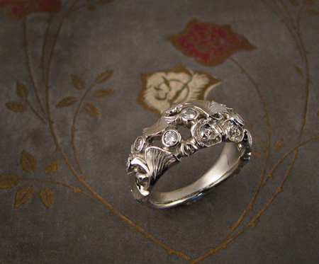 Carved band with roses and ginkgo leaves and diamonds; 14K white gold