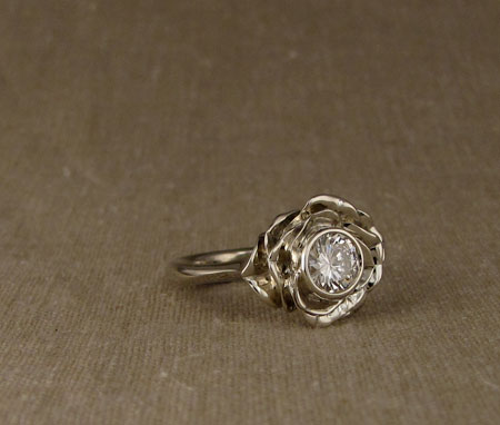 Carved blooming rose solitaire with diamond; 14K white gold