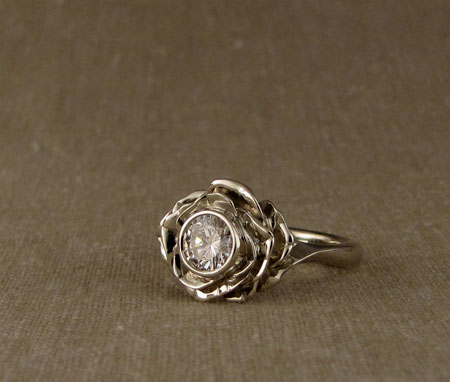 Carved blooming rose solitaire with diamond; 14K white gold