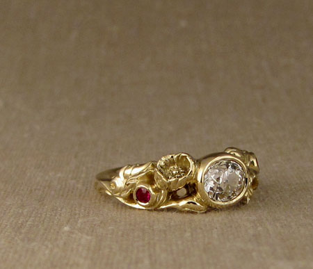 Carved Poppy ring with oval diamond and rubies, 18K