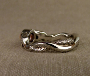 Hand-carved snake solitaire with sapphire