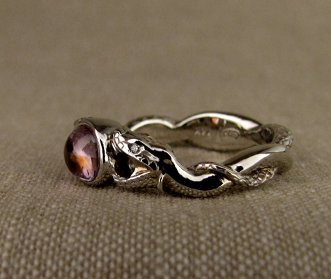 Hand-carved snake solitaire with sapphire