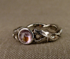 Hand-carved snake solitaire with sapphire