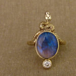 Hand-carved snake cocktail ring with a smoky black opal and OEC diamond, 14K gold