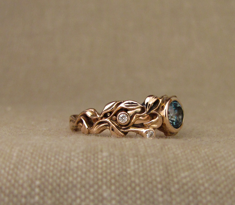 Custom designed & hand-carved blue zircon solitaire in rose gold