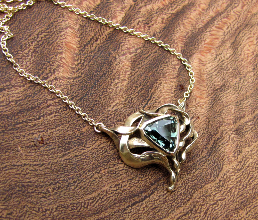 Custom designed & carved Kelp motif pendant set with triangular 2ct blue-green tourmaline