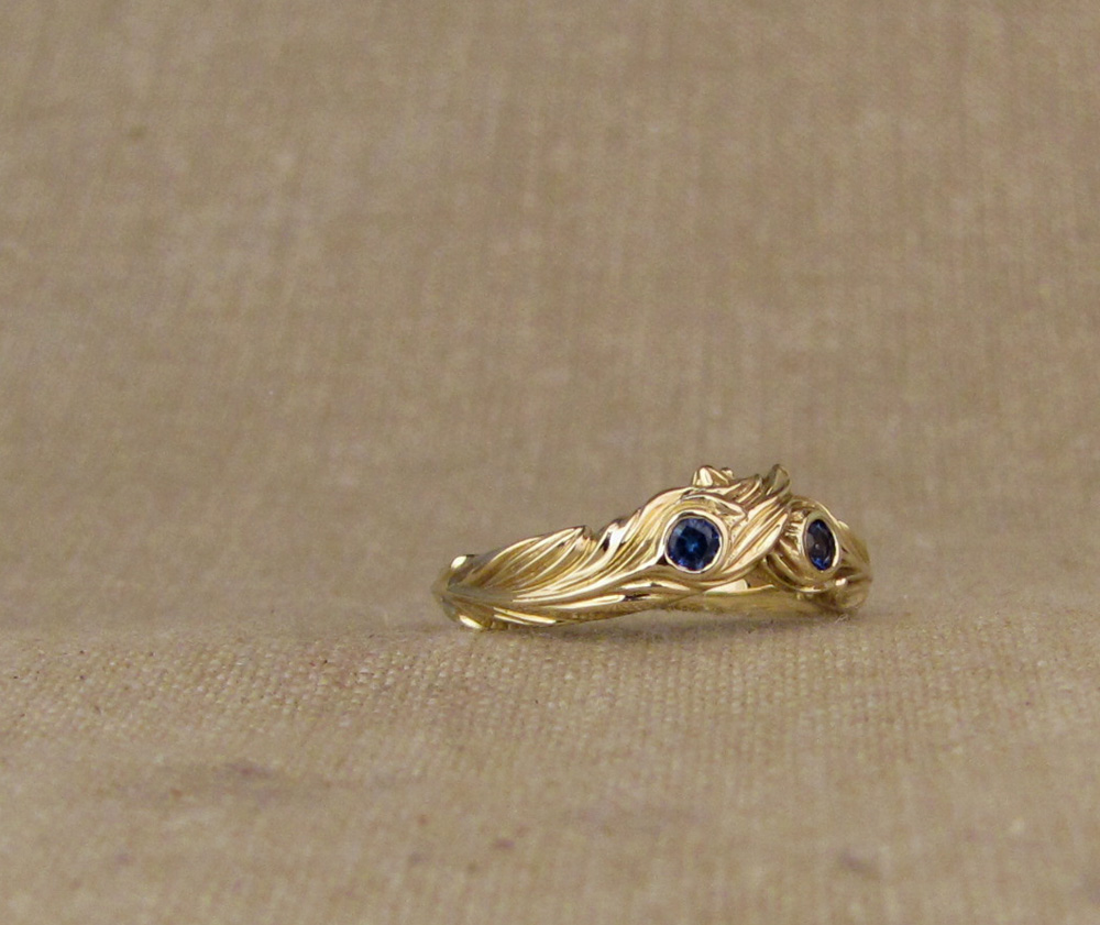 Custom designed & hand carved Phoenix Feathers wedding band in 14K yellow gold, set with blue sapphires