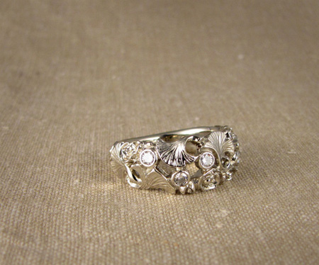 Carved band with roses and ginkgo leaves and diamonds; 14K white gold