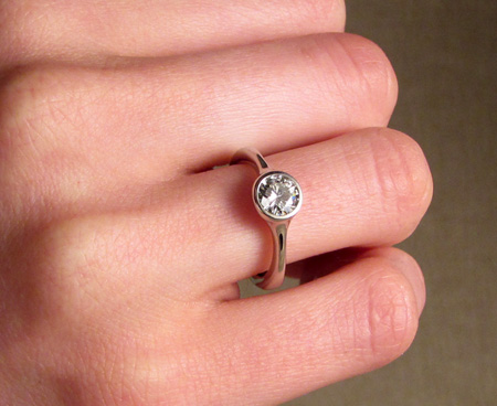 Low-profile solitaire engagement ring in palladium