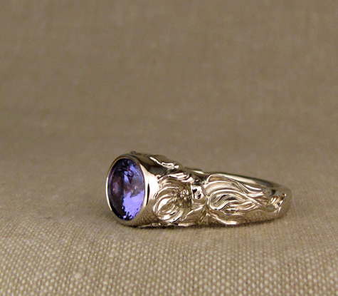 Hand-carved Tanzanite solitaire with poppy motif, 18K