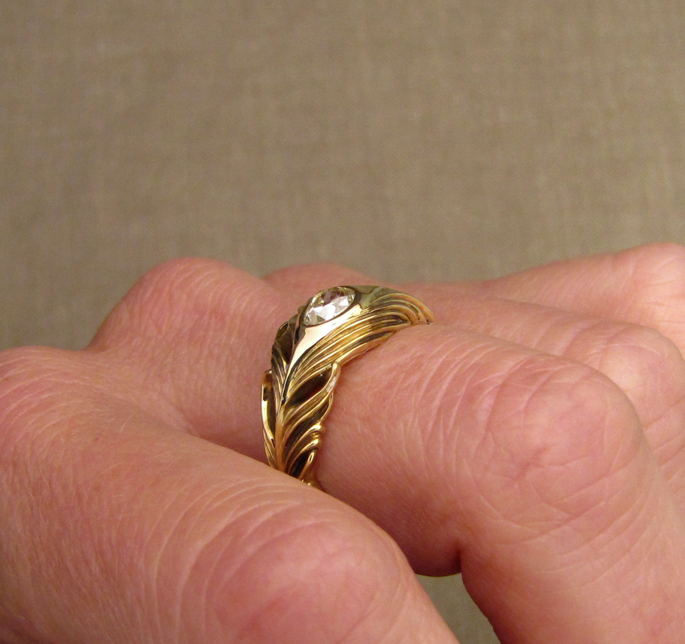 Custom-designed & hand-carved peacock feather ring with an antique pear diamond, 18K gold