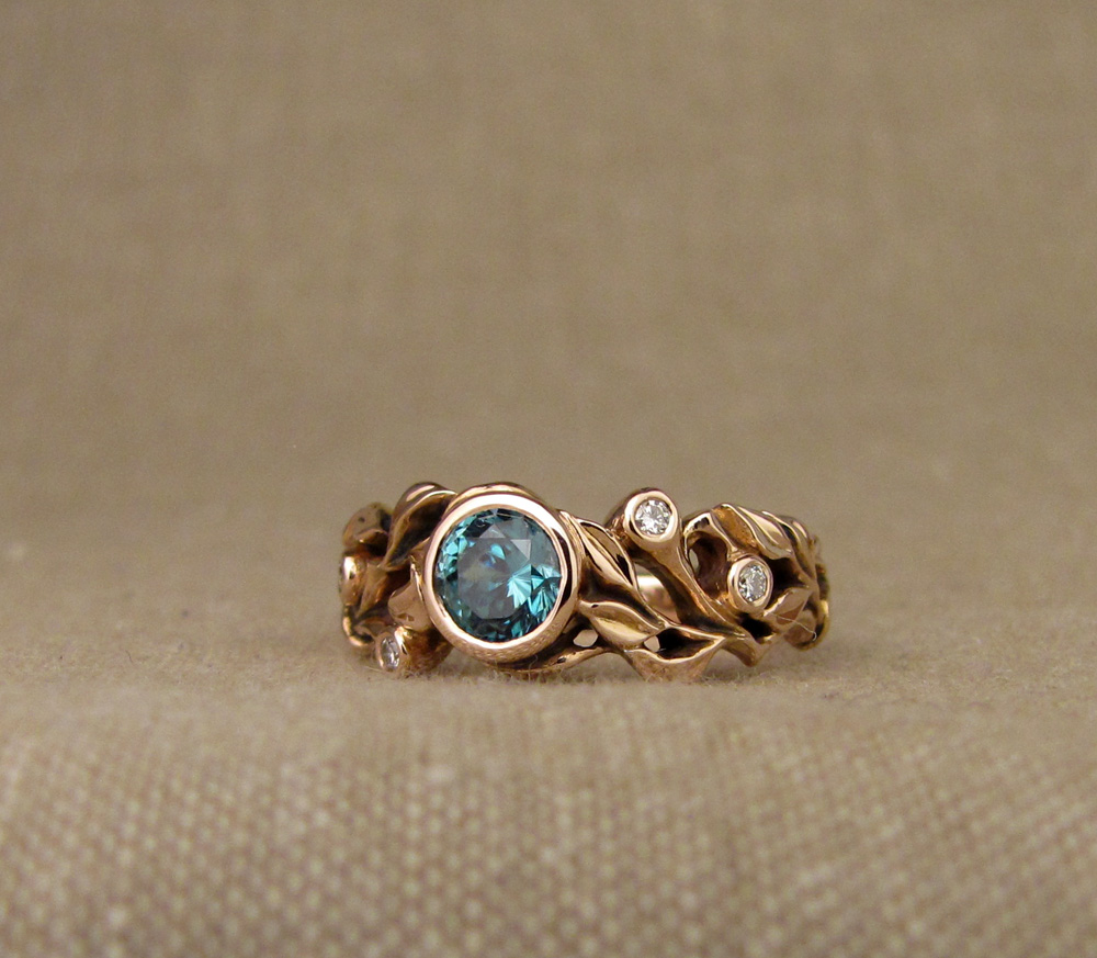 Custom designed & hand-carved blue zircon solitaire in rose gold