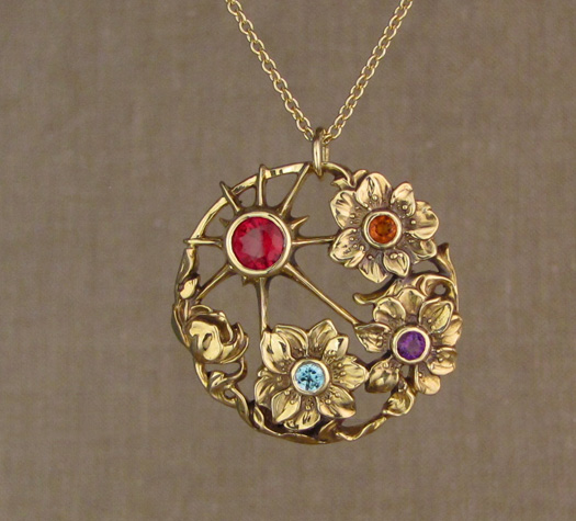 Custom-designed & hand-carved 'Mother's' pendant with ruby, blue zircon, citrine, and amethyst birthstones, in 18K yellow gold.