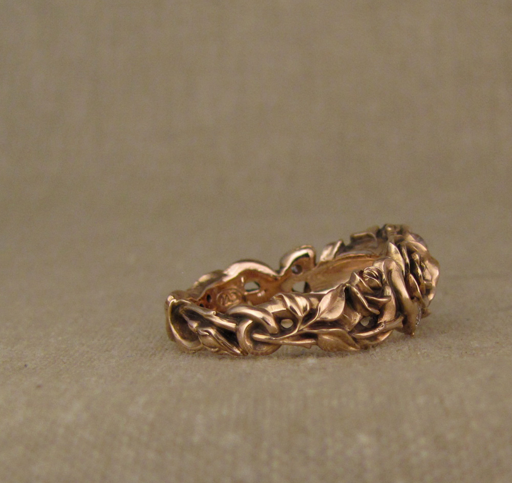 Custom designed & hand-carved Pink diamond solitaire set in quatrefoil setting with snakes and roses, 14K rose gold
