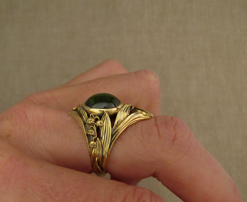 Custom-designed & hand-carved Lily of the Valley Solitaire set with absinthe-green demantoid garnet. 18K gold.