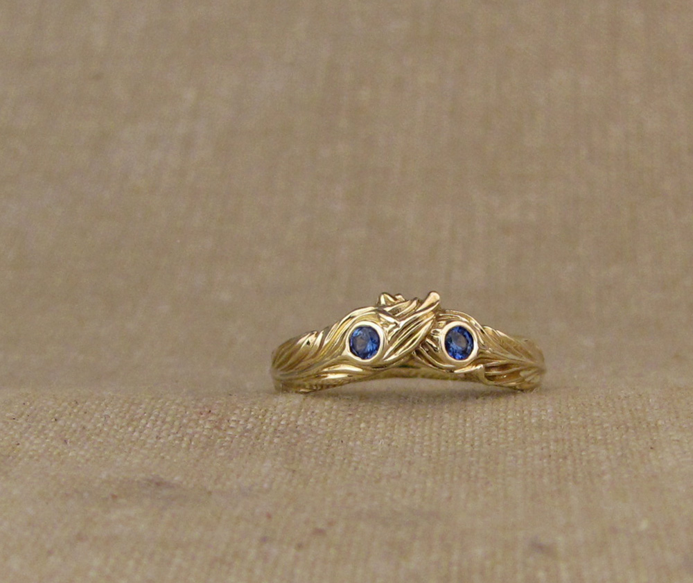Custom designed & hand carved Phoenix Feathers wedding band in 14K yellow gold, set with blue sapphires