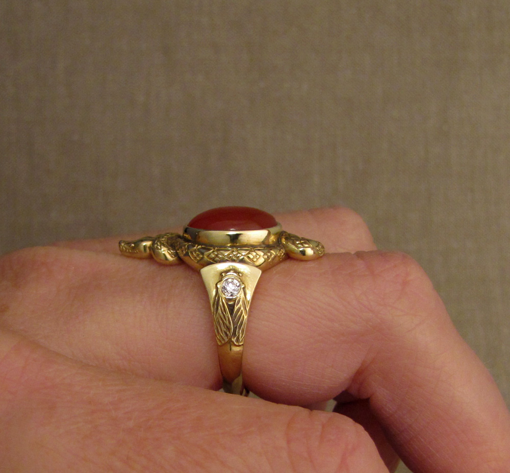 Custom designed & hand-carved Snake ring set with carnelian and antique Old European cut diamonds; cicada & Pleiades motifs on shoulders, dogwood blossom on the base. 