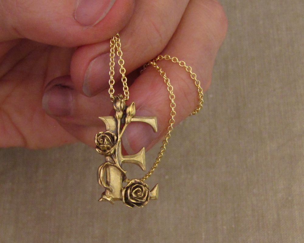 Custom hand-carved 'E' initial pendant with roses, 18K gold