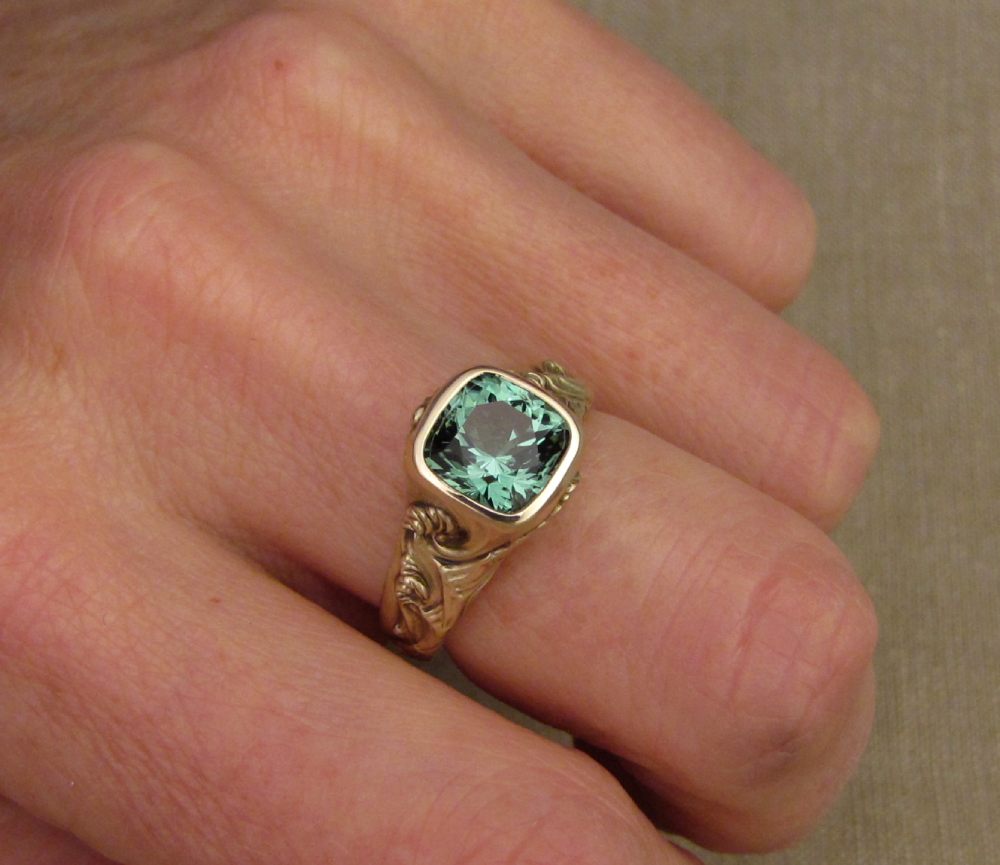 Hand-carved Hokusai-inspired Great Wave solitaire with blue-green tourmaline, 14K yellow gold