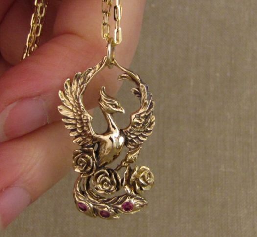 Hand-carved phoenix pendant with roses and rhodolite, 14K yellow gold