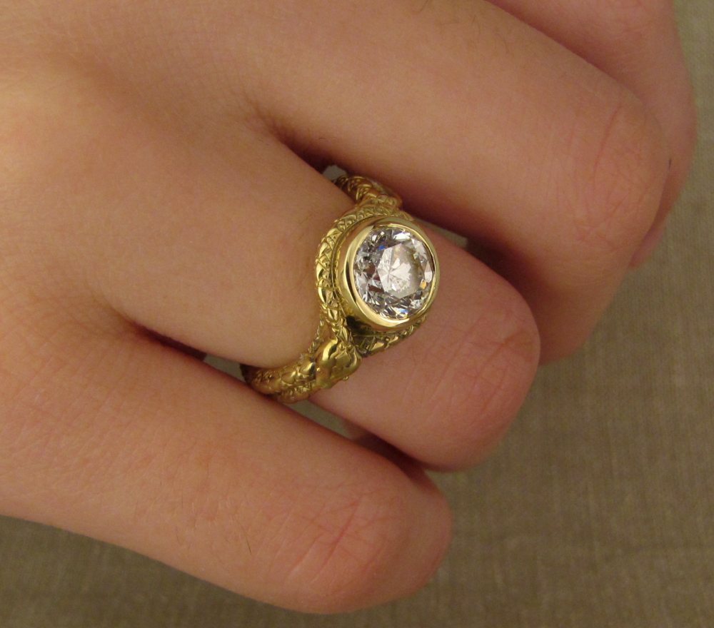 Custom designed, hand-carved Coiled Snake Solitaire in 18K gold with diamond