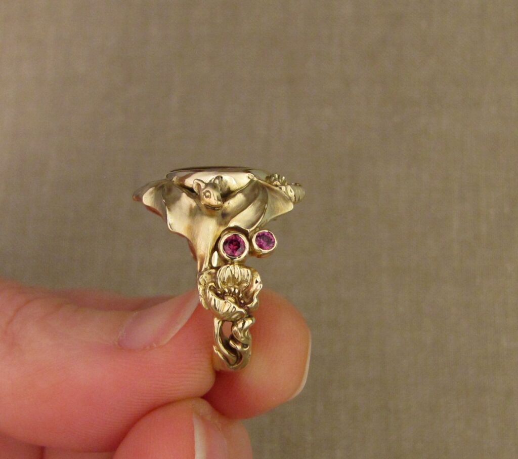 Bats & Poppies Ring, set with a fire agate and berry-colored garnets, 14K gold, cheyenne weil jewelry