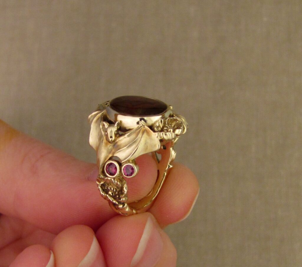 Bats & Poppies Ring, set with a fire agate and berry-colored garnets, 14K gold, cheyenne weil jewelry