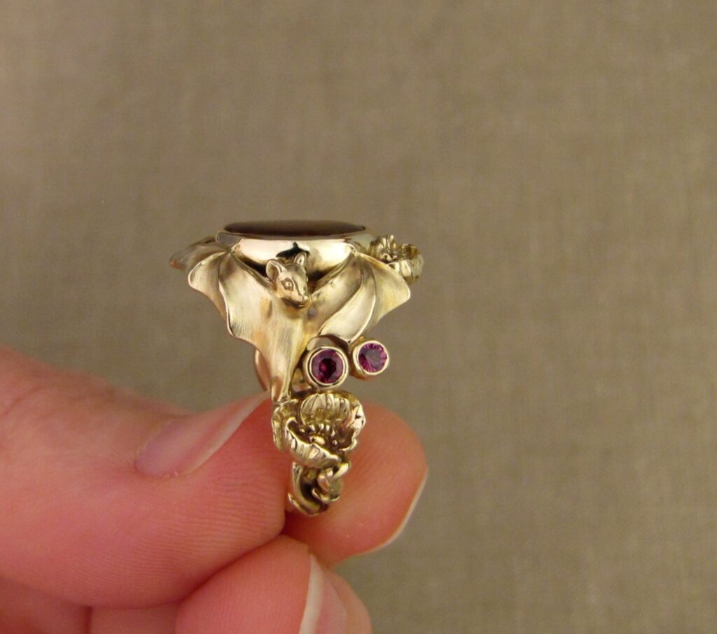 Bats & Poppies Ring, set with a fire agate and berry-colored garnets, 14K gold, cheyenne weil jewelry