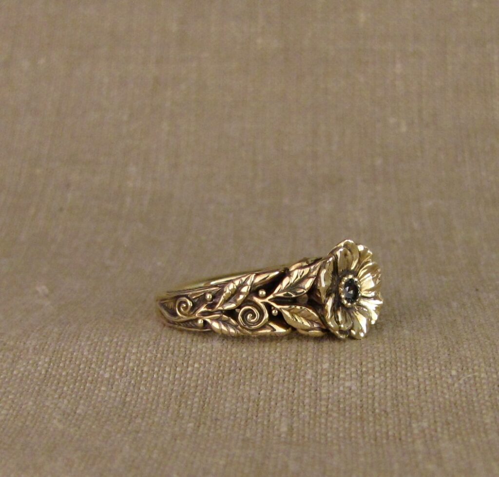 Hand-carved Egrets with Anemone flower and vines, leaves. Set with teal sapphire, 14K gold, cheyenne weil jewelry