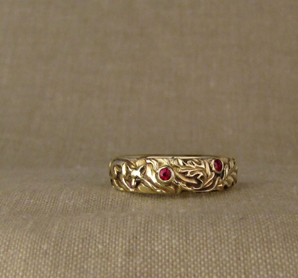 Wedding band carved with fox, tree of life, oak leaves, rococo-leaf motif, set with rubies, 14K gold, cheyenne weil jewelry