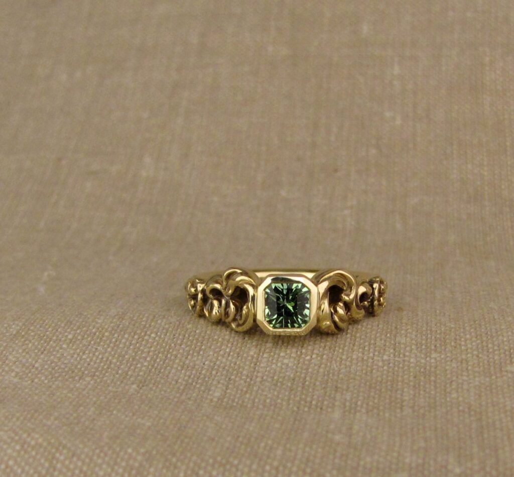 Custom Ocean waves with shells solitaire, set with seafoam-green garnet, 18K yellow gold, cheyenne weil jewelry