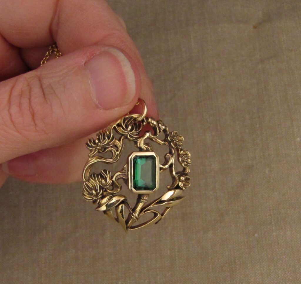 Three friends of Winter pendant (plum, pine, bamboo) hand carved, 14K yellow gold, green tourmaline. Cheyenne Weil