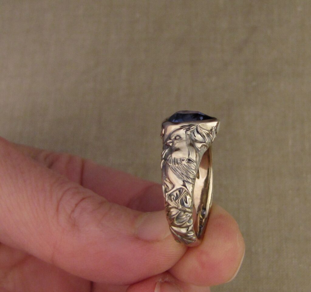 Custom carved Sapphire Solitaire with Quail and Cardinal motifs. Palladium white gold, Blue sapphire, Cheyenne Weil