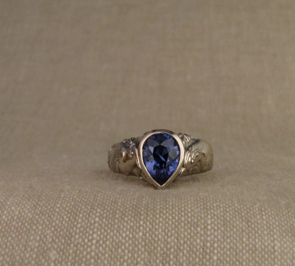 Custom carved Sapphire Solitaire with Quail and Cardinal motifs. Palladium white gold, Blue sapphire, Cheyenne Weil