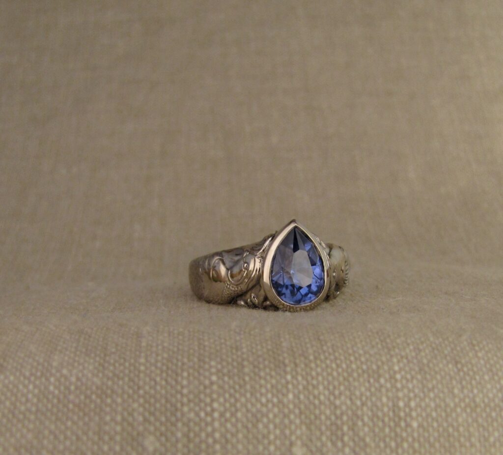 Custom carved Sapphire Solitaire with Quail and Cardinal motifs. Palladium white gold, Blue sapphire, Cheyenne Weil