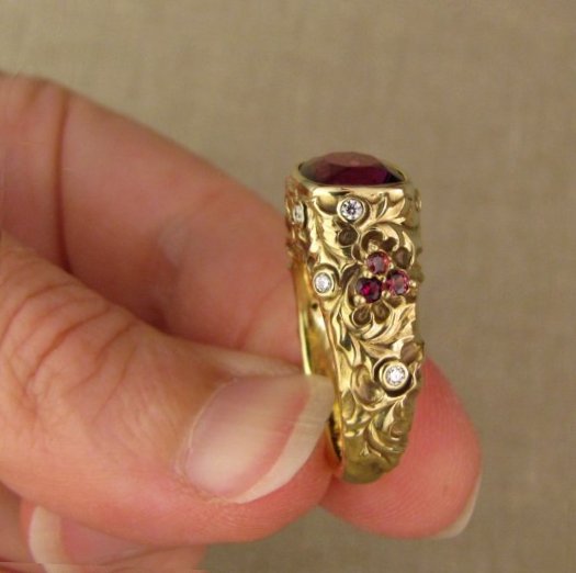 Custom designed & hand-carved Berry-colored garnet, Ivy and Holly Leaves with pine bough motifs, diamonds & multi-colored garnet berries. 18K yellow gold