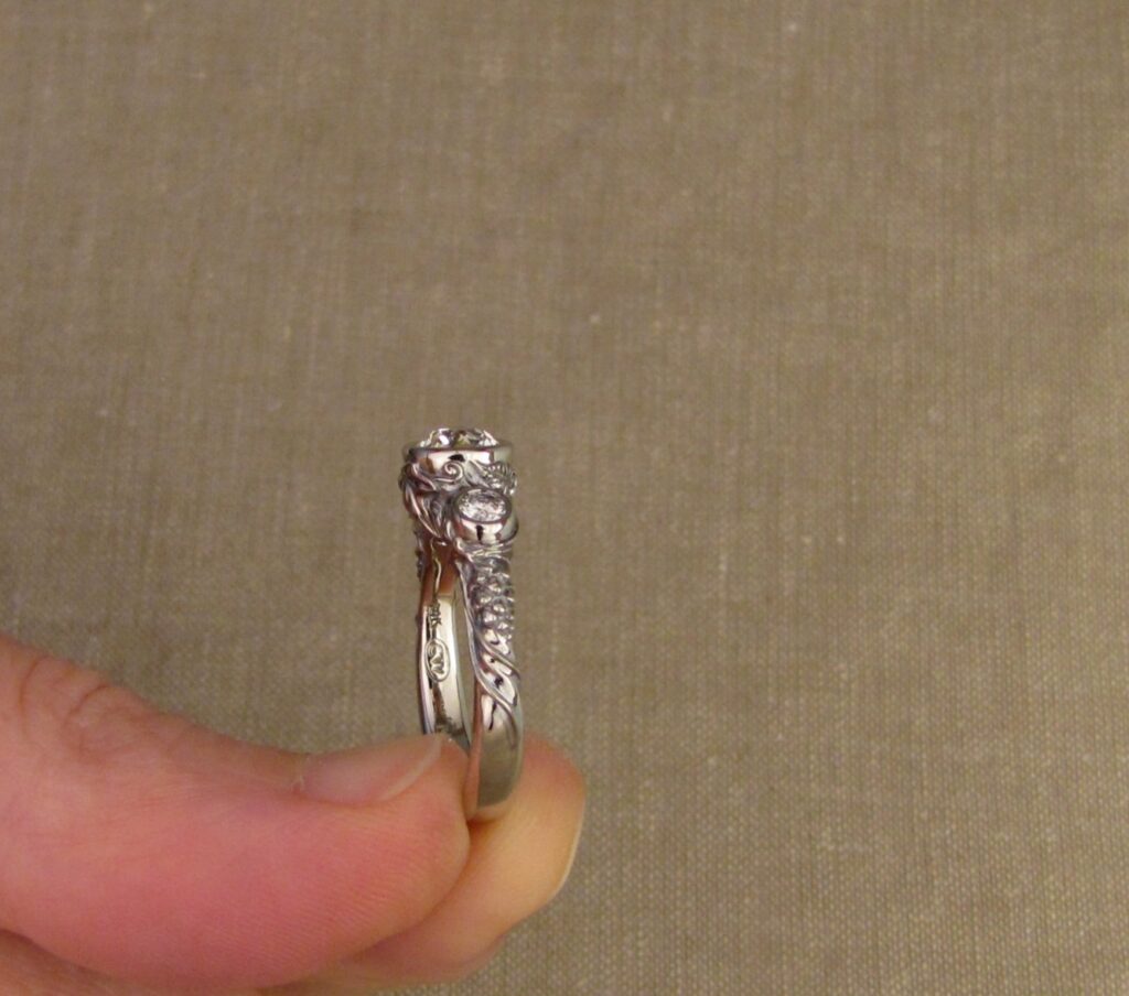 Custom Designed & Hand-carved Three-stone solitaire with antique Old European Cut diamond. Ferns, ivy, pinecones motifs, 14K white gold.