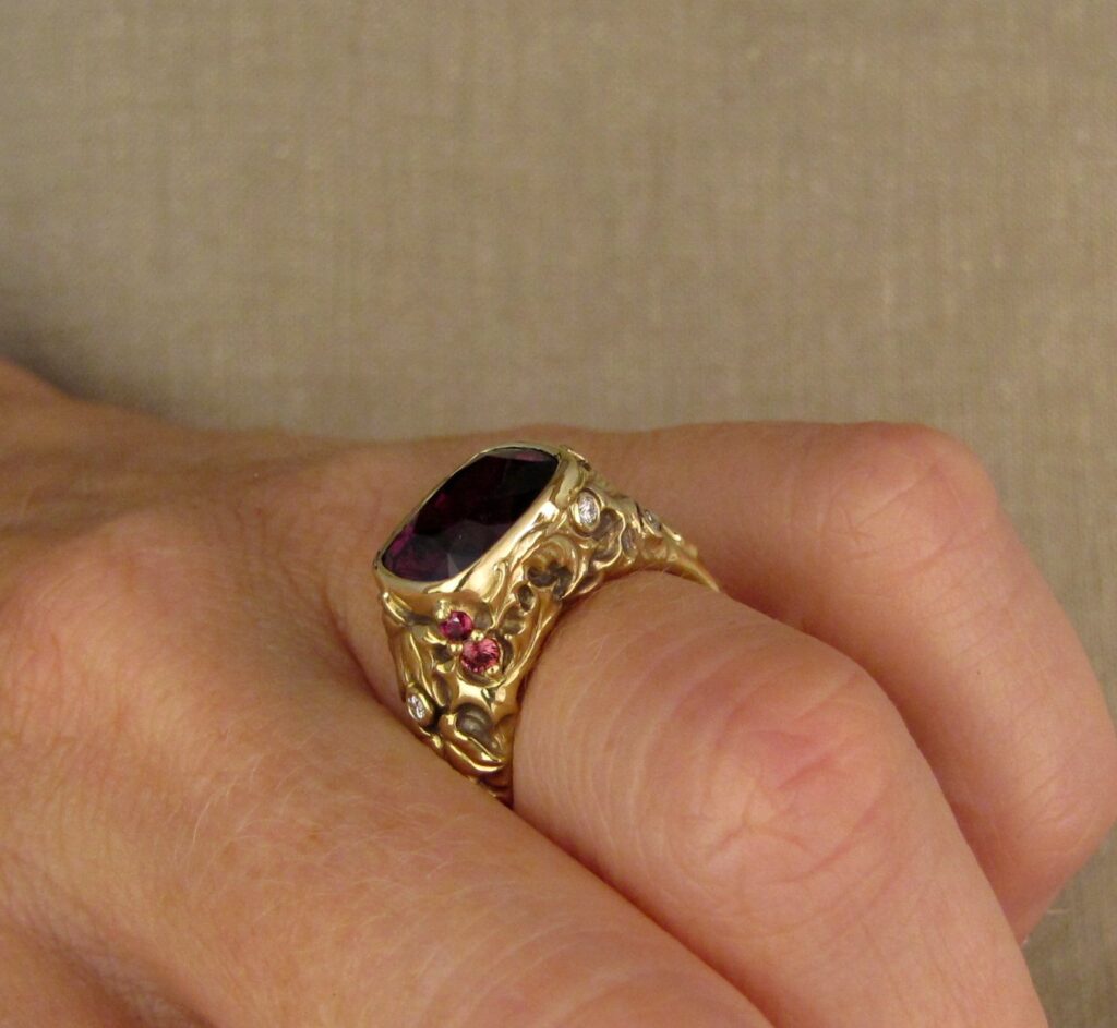 Custom designed & hand-carved Berry-colored garnet, Ivy and Holly Leaves with pine bough motifs, diamonds & multi-colored garnet berries. 18K yellow gold