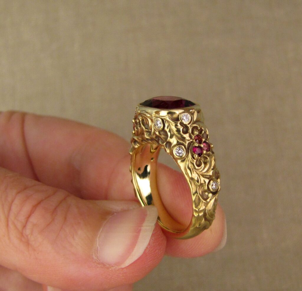 Custom designed & hand-carved Berry-colored garnet, Ivy and Holly Leaves with pine bough motifs, diamonds & multi-colored garnet berries. 18K yellow gold