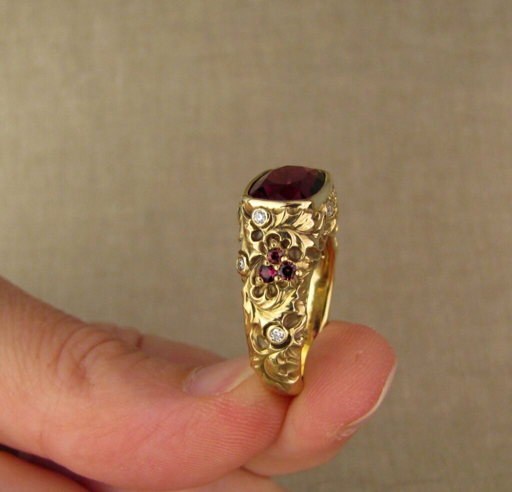 Custom designed & hand-carved Berry-colored garnet, Ivy and Holly Leaves with pine bough motifs, diamonds & multi-colored garnet berries. 18K yellow gold