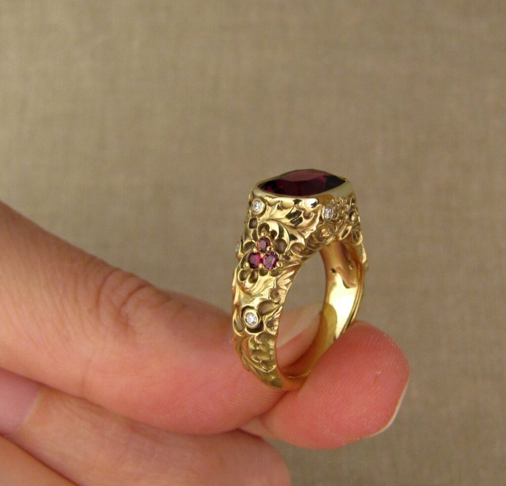 Custom designed & hand-carved Berry-colored garnet, Ivy and Holly Leaves with pine bough motifs, diamonds & multi-colored garnet berries. 18K yellow gold