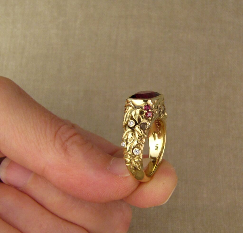Custom designed & hand-carved Berry-colored garnet, Ivy and Holly Leaves with pine bough motifs, diamonds & multi-colored garnet berries. 18K yellow gold