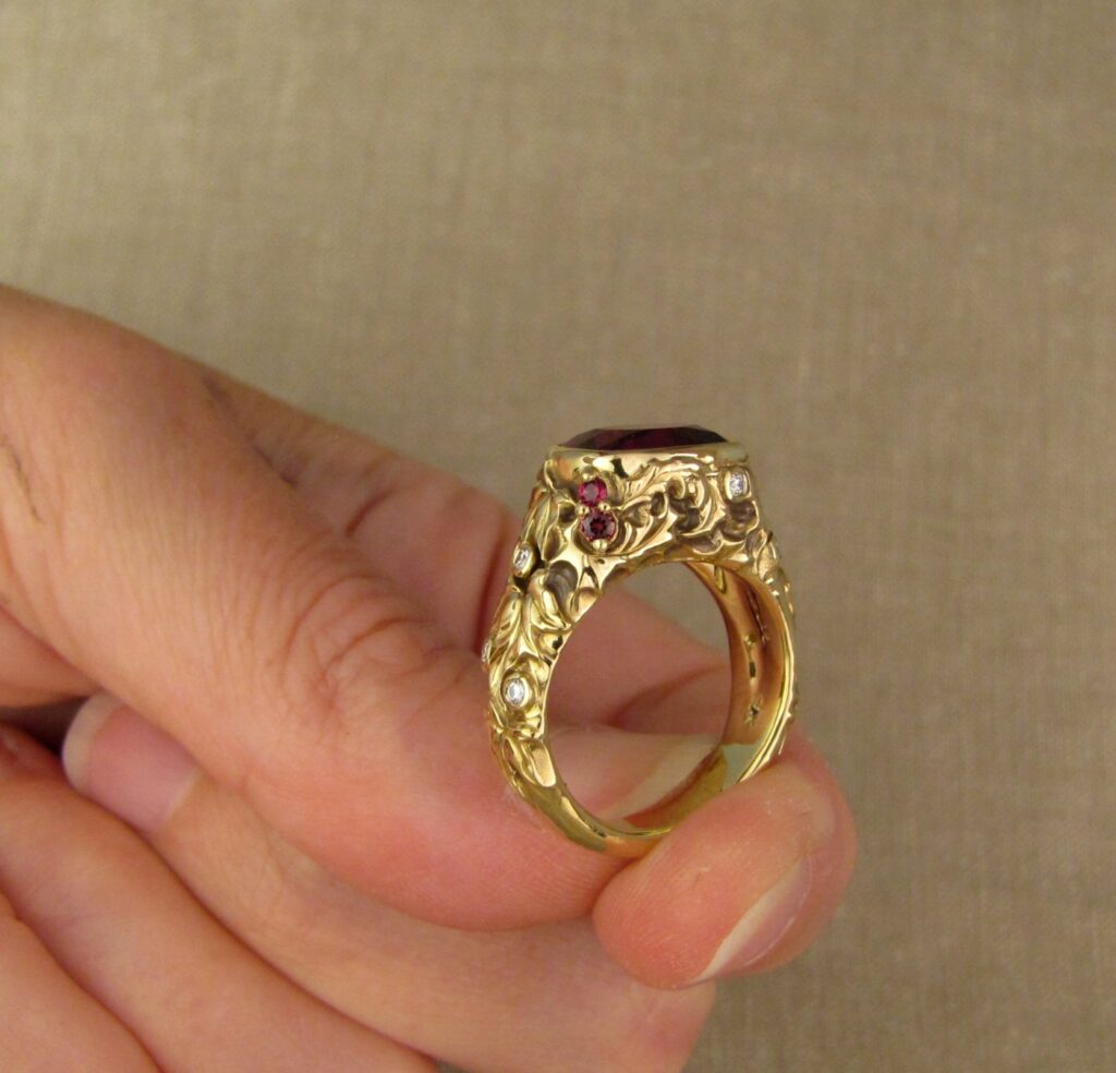 Custom designed & hand-carved Berry-colored garnet, Ivy and Holly Leaves with pine bough motifs, diamonds & multi-colored garnet berries. 18K yellow gold