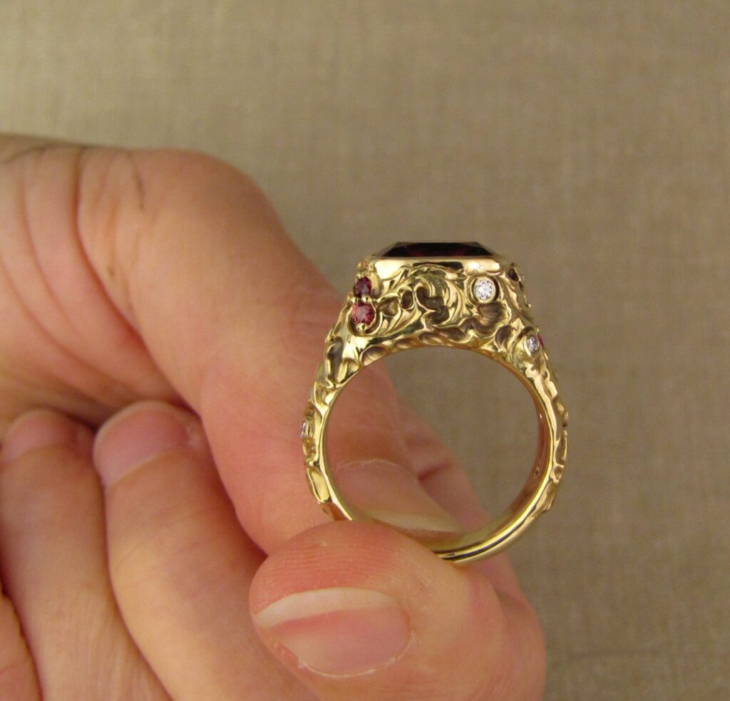 Custom designed & hand-carved Berry-colored garnet, Ivy and Holly Leaves with pine bough motifs, diamonds & multi-colored garnet berries. 18K yellow gold