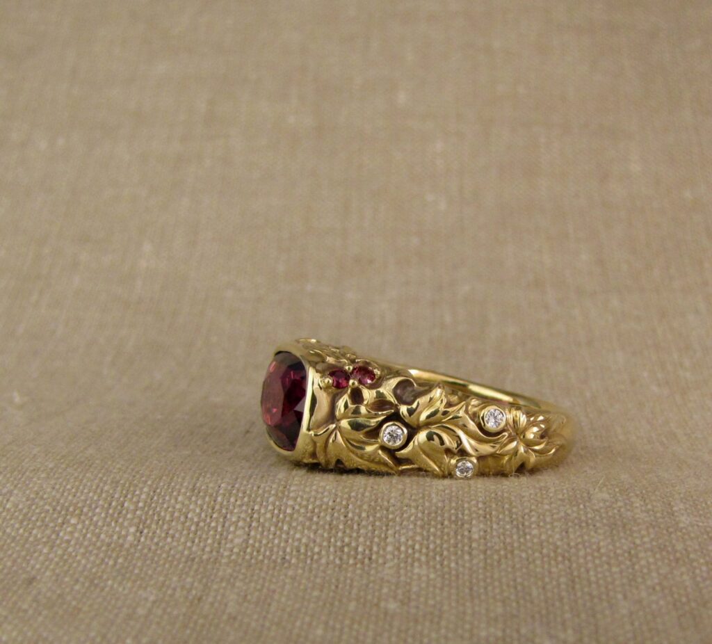 Custom designed & hand-carved Berry-colored garnet, Ivy and Holly Leaves with pine bough motifs, diamonds & multi-colored garnet berries. 18K yellow gold