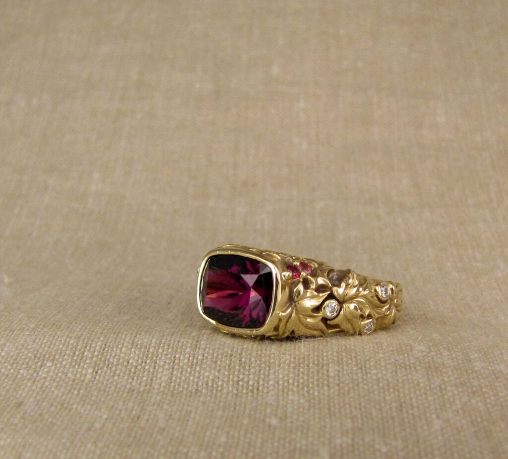 Custom designed & hand-carved Berry-colored garnet, Ivy and Holly Leaves with pine bough motifs, diamonds & multi-colored garnet berries. 18K yellow gold