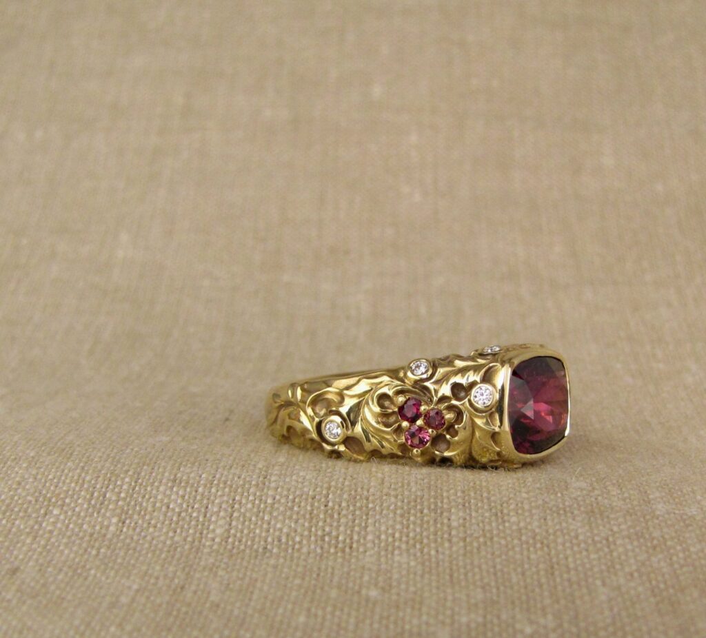 Custom designed & hand-carved Berry-colored garnet, Ivy and Holly Leaves with pine bough motifs, diamonds & multi-colored garnet berries. 18K yellow gold