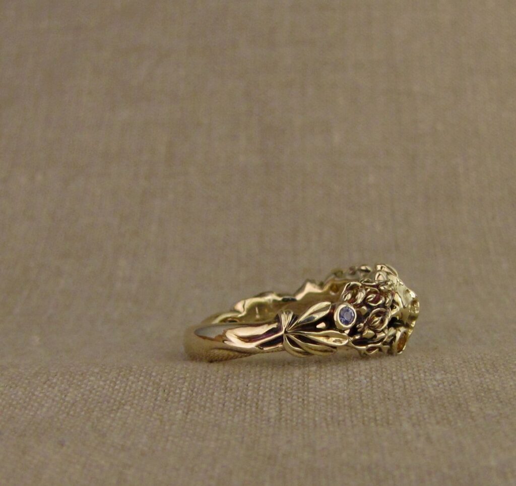 Custom designed & hand-carved California Poppies and Texas Bluebonnets ring in 14K gold with blue sapphires & yellow-orange spessartite garnets. Cheyenne Weil