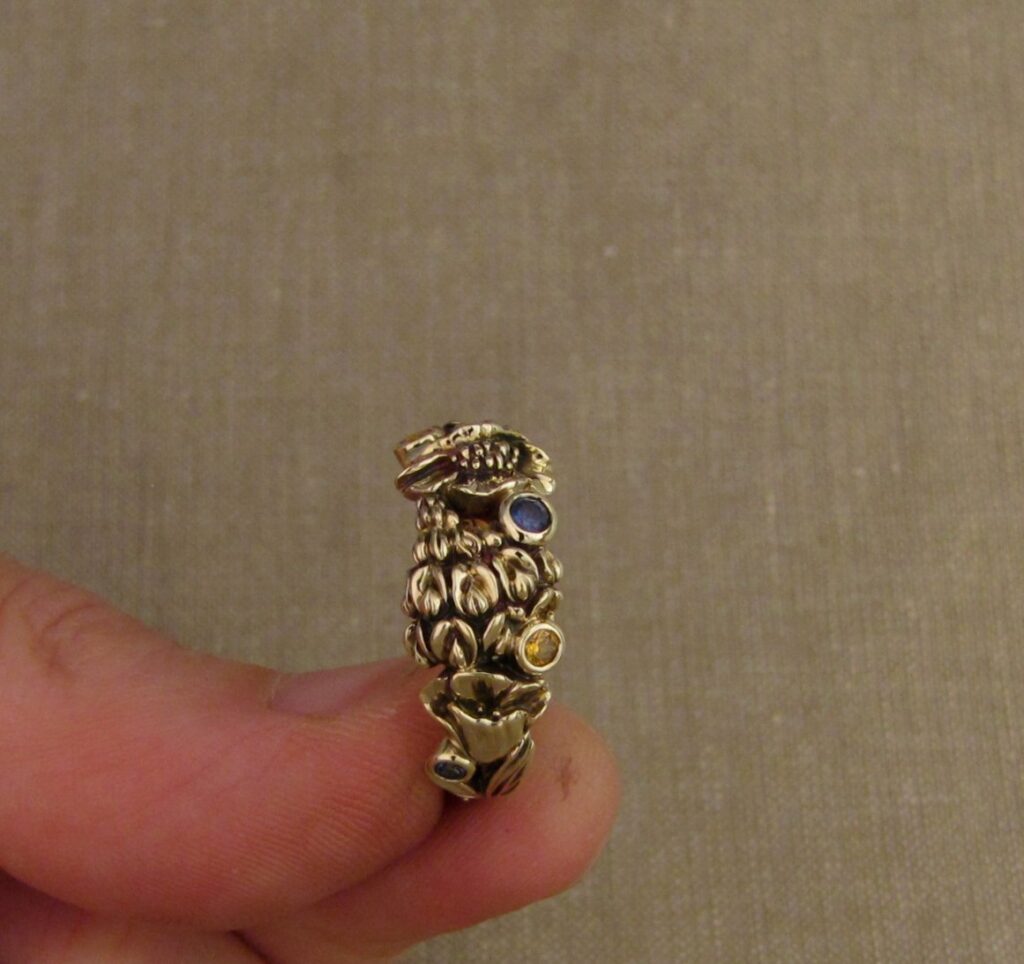 Custom designed & hand-carved California Poppies and Texas Bluebonnets ring in 14K gold with blue sapphires & yellow-orange spessartite garnets. Cheyenne Weil